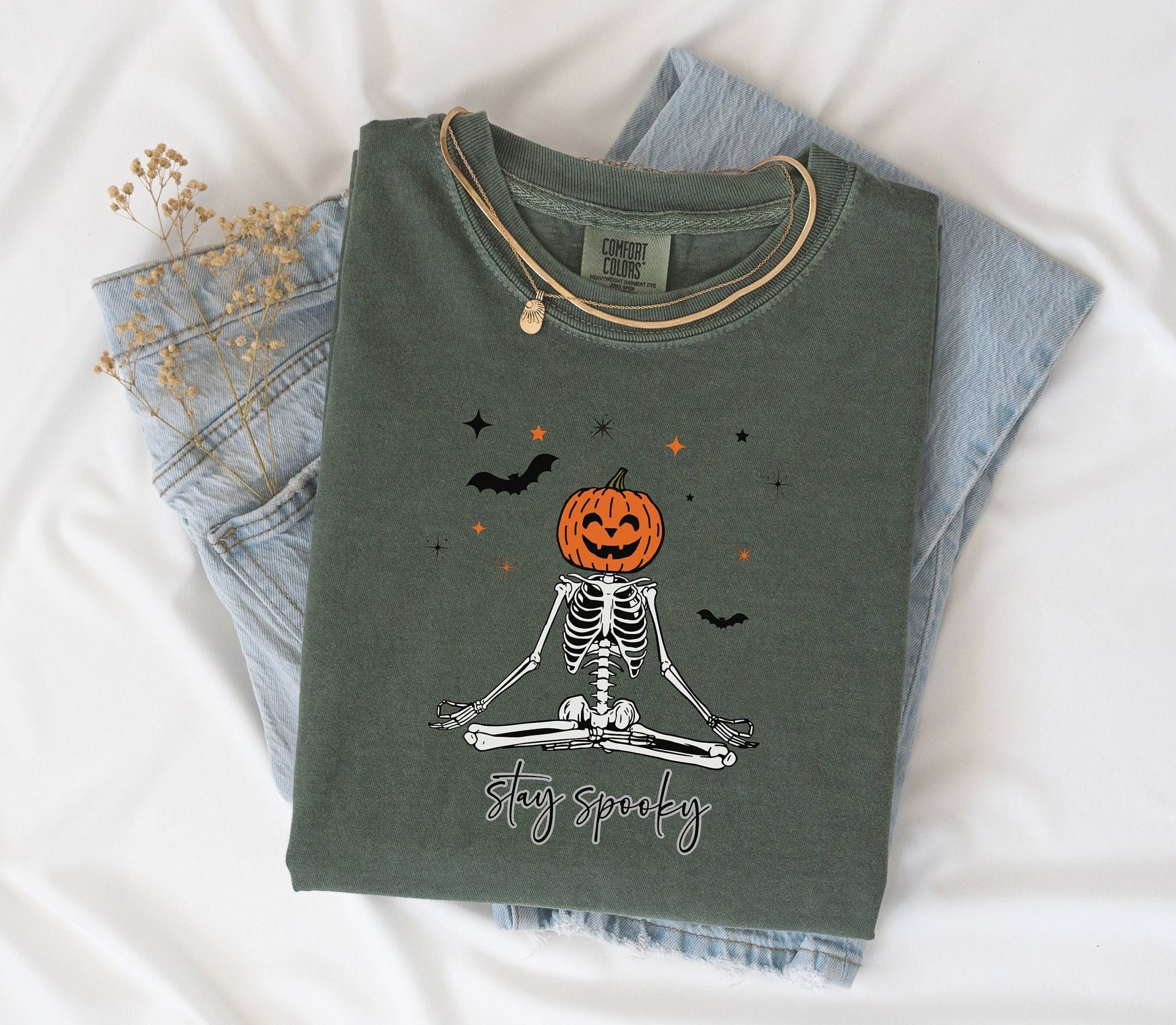 Stay Spooky design on a moss colored t-shirt